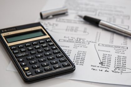 black-calculator-near-ballpoint-pen-on-white-printed-paper-53621